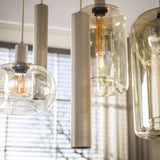 Hängelampe Sera 7-flammig, beiges Metall, bernsteinfarbenes Glas