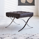 Fußhocker Expo Premium Dimehouse Dunkelbraun LxBxH 63x62x36 Leder Stimmungsvolles Foto diagonal von vorne